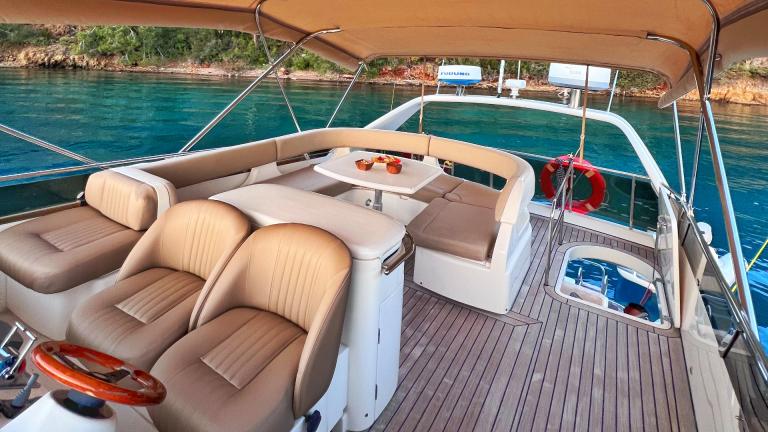 Flybridge with upholstered chairs on the motor yacht Hadron